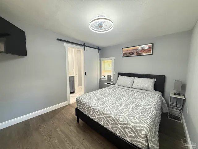 a bedroom with a bed and a flat screen tv