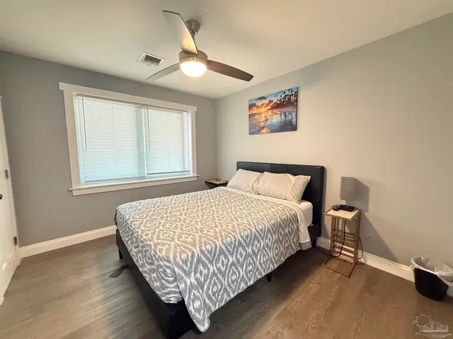 a bedroom with a bed lamp and a window