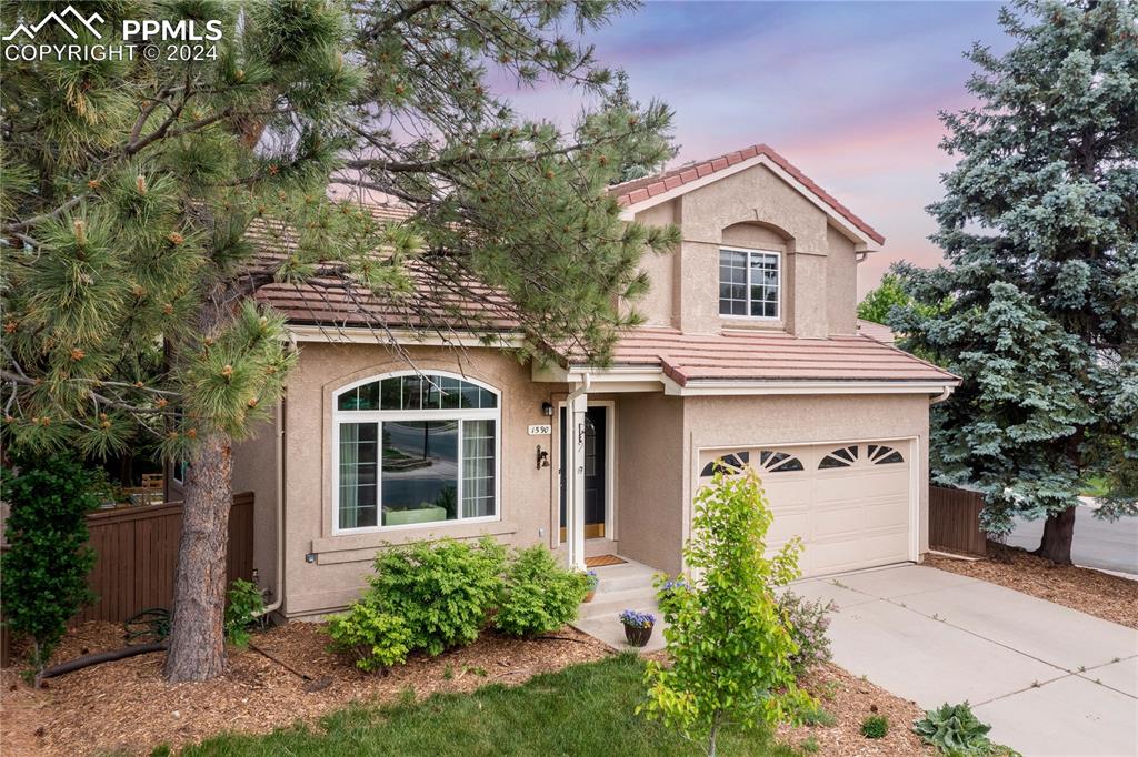 1590 Spring Water Way Highlands Ranch, CO 80129 - Photo 2 of 44 a view of a white house with a large windows and a large tree