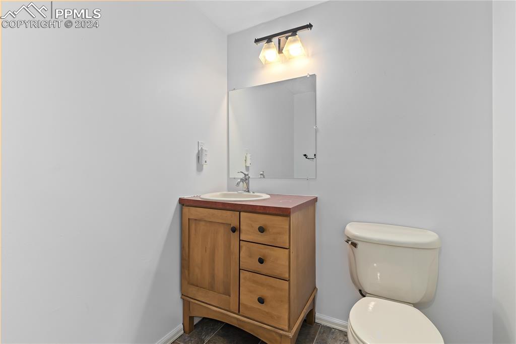 1590 Spring Water Way Highlands Ranch, CO 80129 - Photo 33 of 44 a bathroom with a toilet sink and mirror