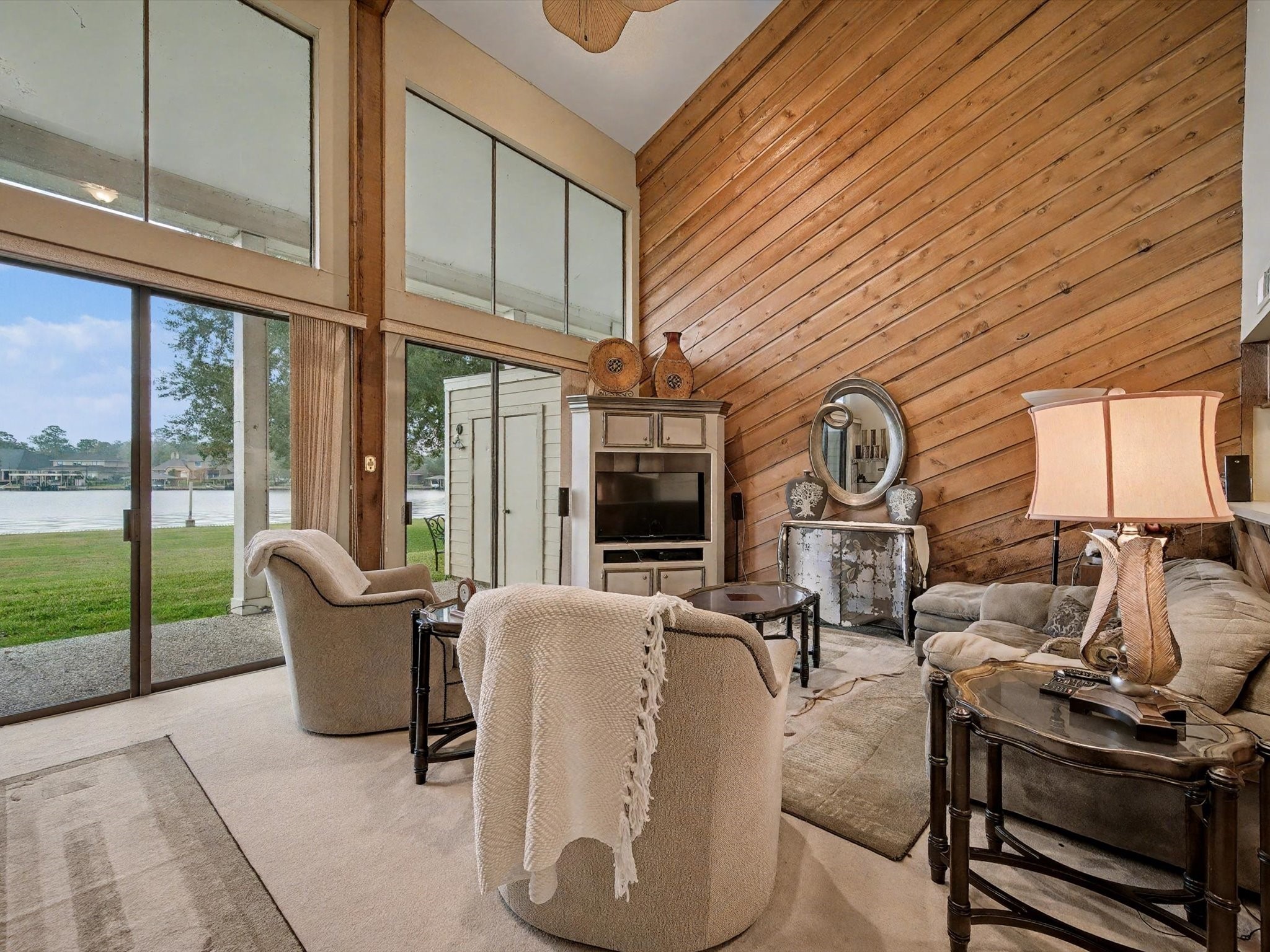 75 April Point Drive South Conroe, TX 77356 - Photo 1 of 18 a living room with furniture a fireplace and large windows