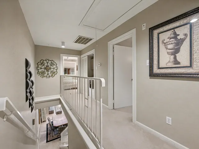 a view of staircase with lots of frames on wall and couches