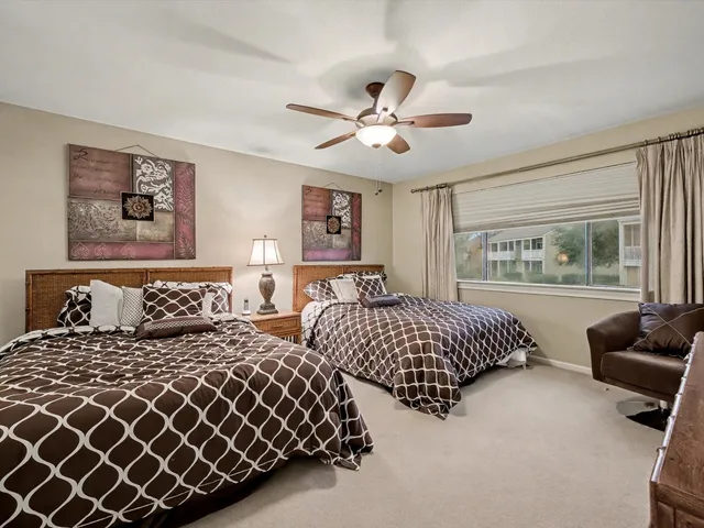 a bedroom with two beds and a couch