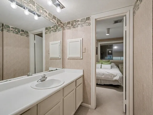 a en suite bathroom with a sink double vanity and shower