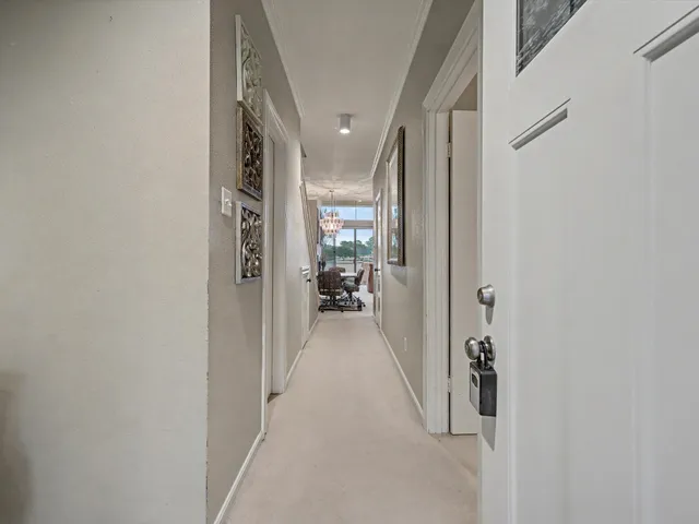 a view of a hallway with a livingroom and having having tops