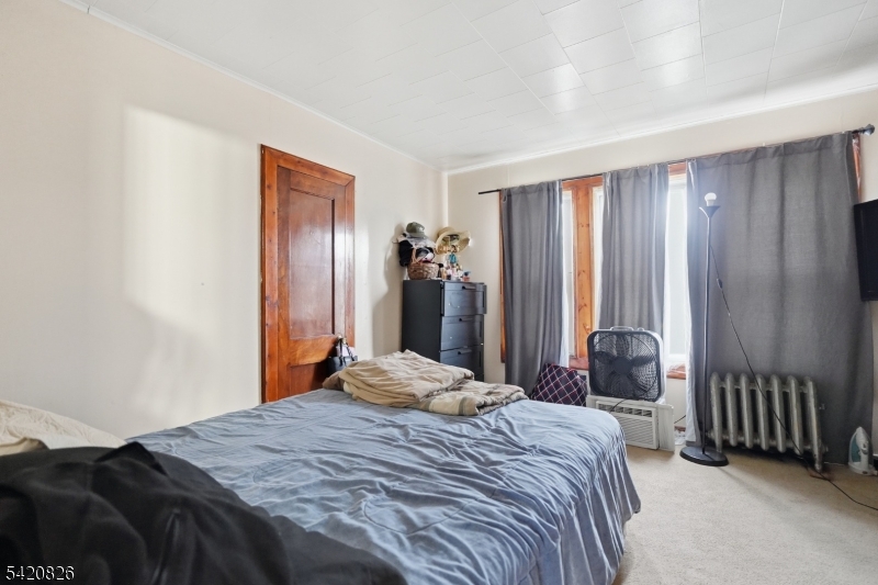 923-925 Kilsyth Road Elizabeth, NJ 07208 - Photo 12 of 24 a bedroom with a bed and a large mirror