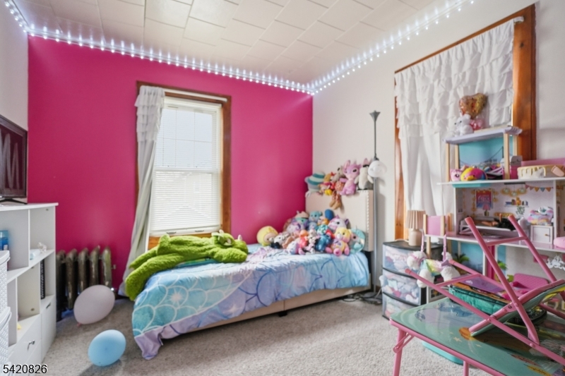 923-925 Kilsyth Road Elizabeth, NJ 07208 - Photo 13 of 24 a bedroom with a bed and a window