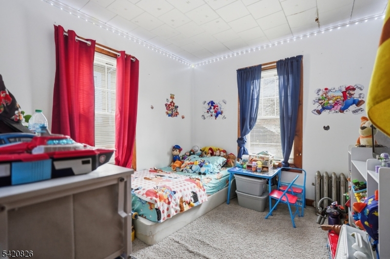 923-925 Kilsyth Road Elizabeth, NJ 07208 - Photo 14 of 24 a bedroom with furniture and a bed