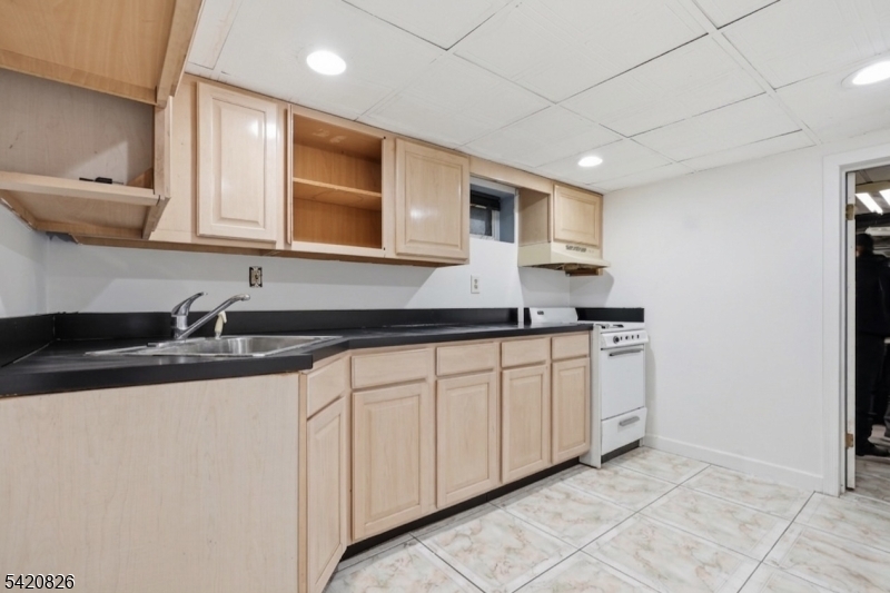 923-925 Kilsyth Road Elizabeth, NJ 07208 - Photo 17 of 24 a kitchen with granite countertop a sink and a stove