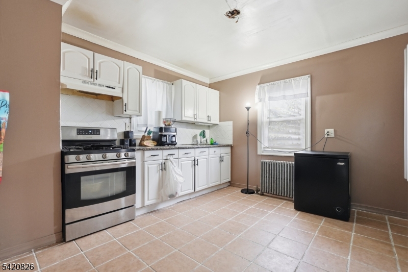 923-925 Kilsyth Road Elizabeth, NJ 07208 - Photo 10 of 24 a kitchen with a cabinets and steel stainless steel appliances