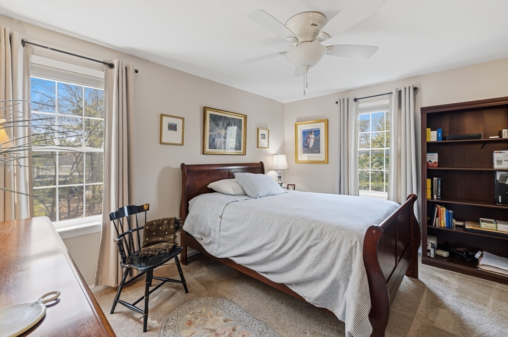 1 Susan Carsley Way Sandwich, MA 02563 - Photo 14 of 39 a bedroom with a bed a table and a book shelf