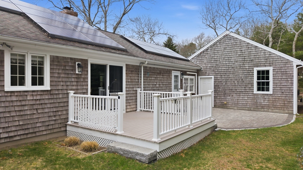1 Susan Carsley Way Sandwich, MA 02563 - Photo 26 of 39 a view of a house with a small deck and a floor to ceiling window