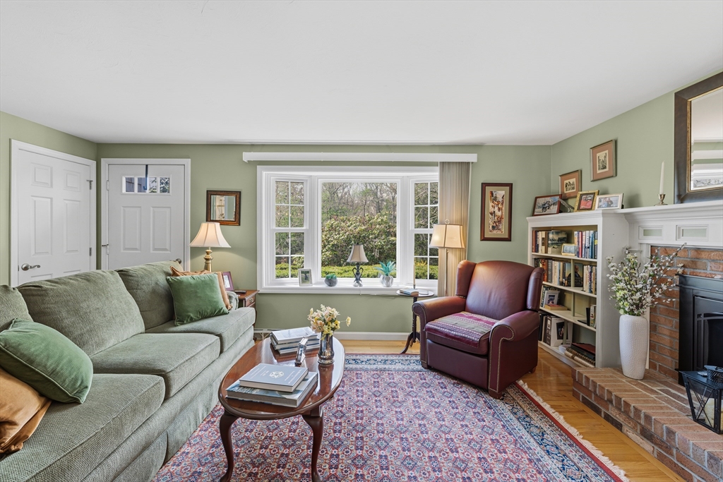 1 Susan Carsley Way Sandwich, MA 02563 - Photo 35 of 39 a living room with furniture a fireplace and a large window