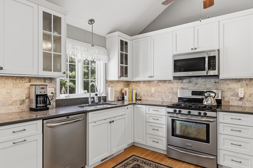 1 Susan Carsley Way Sandwich, MA 02563 - Photo 38 of 39 a kitchen with stainless steel appliances white cabinets and a stove top oven