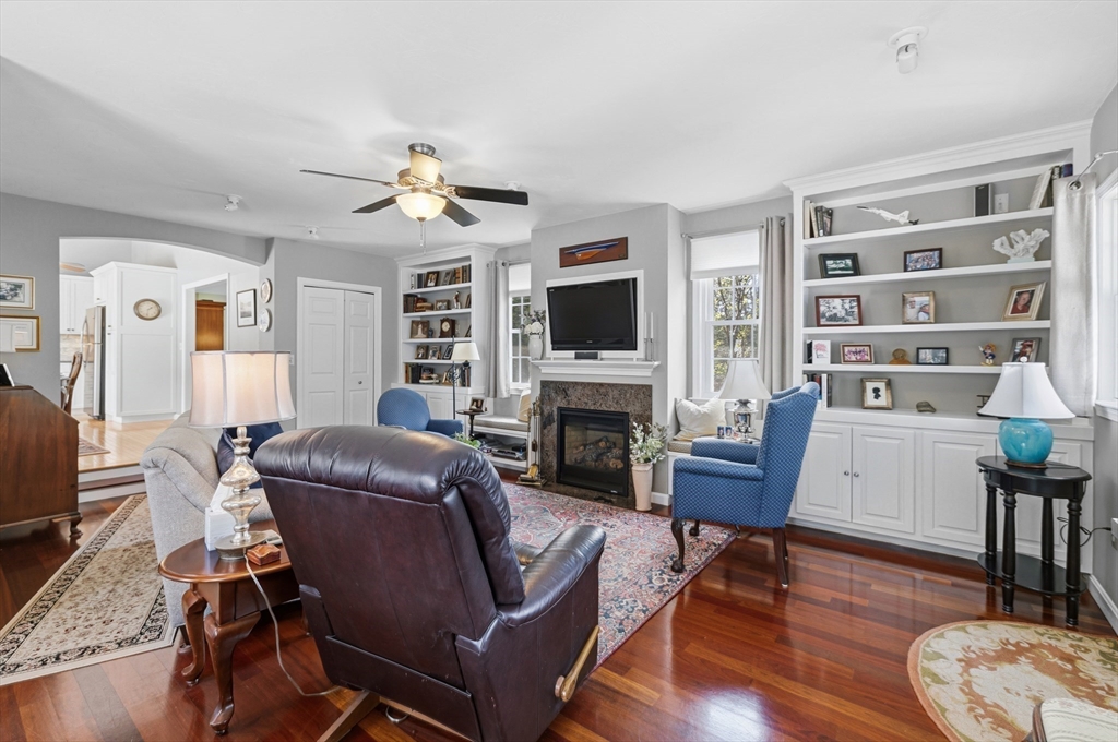 1 Susan Carsley Way Sandwich, MA 02563 - Photo 4 of 39 a living room with furniture a fireplace and a flat screen tv