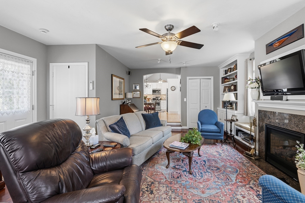 1 Susan Carsley Way Sandwich, MA 02563 - Photo 9 of 39 a living room with furniture a flat screen tv and a fireplace