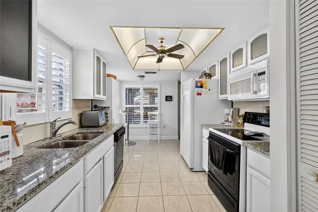 a kitchen that has a lot of cabinets in it and appliances