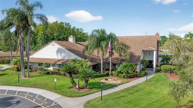 a view of a swimming pool with a patio and a yard