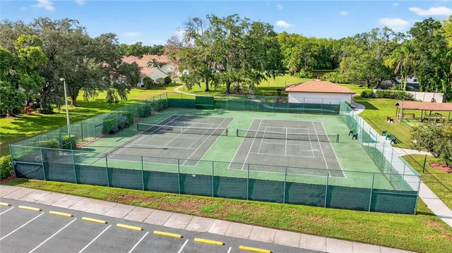 a view of a brick house with a big yard and plants