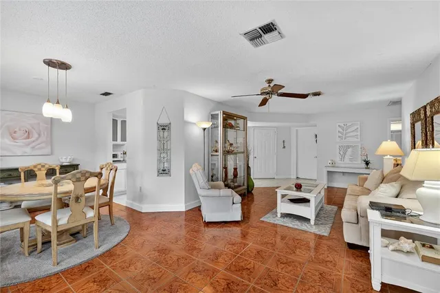 a living room with furniture a rug and white walls