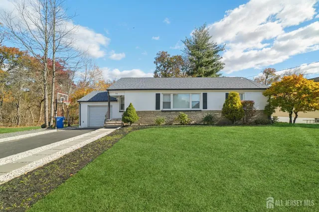 a front view of a house with a garden