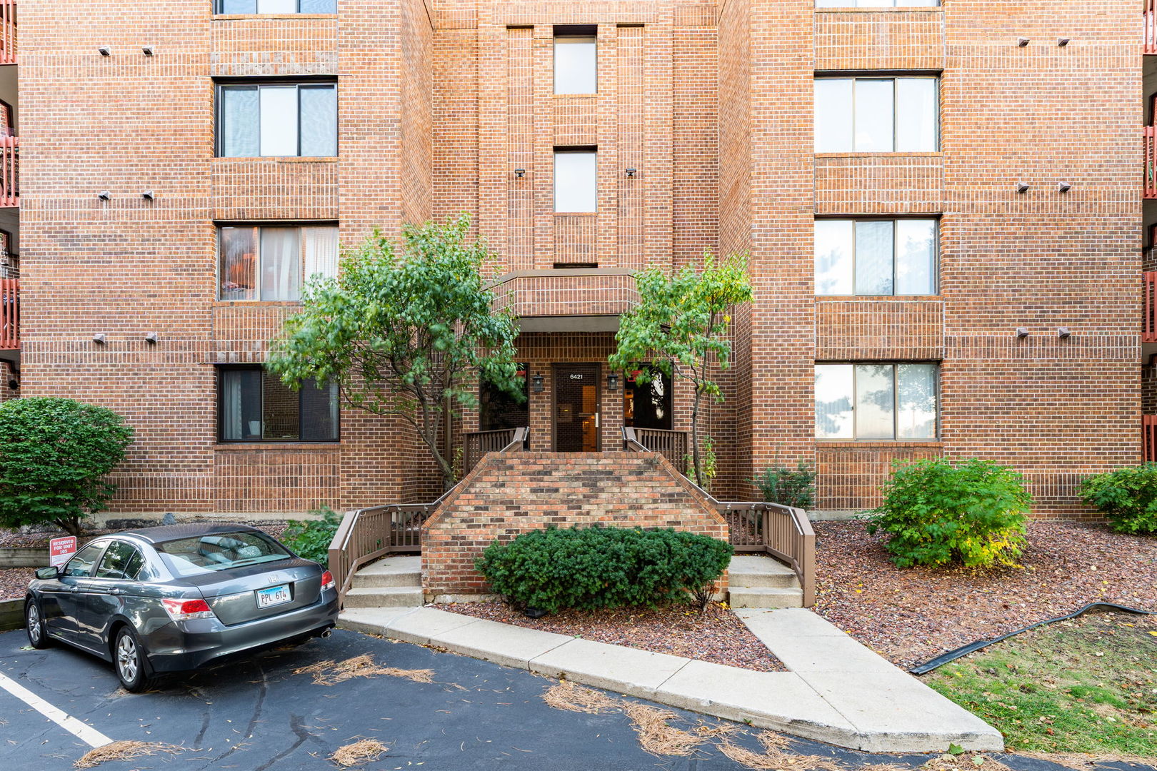 6421 Pershing Road, Unit 404 Berwyn, IL 60402 - Photo 2 of 31 a front view of a house with a yard
