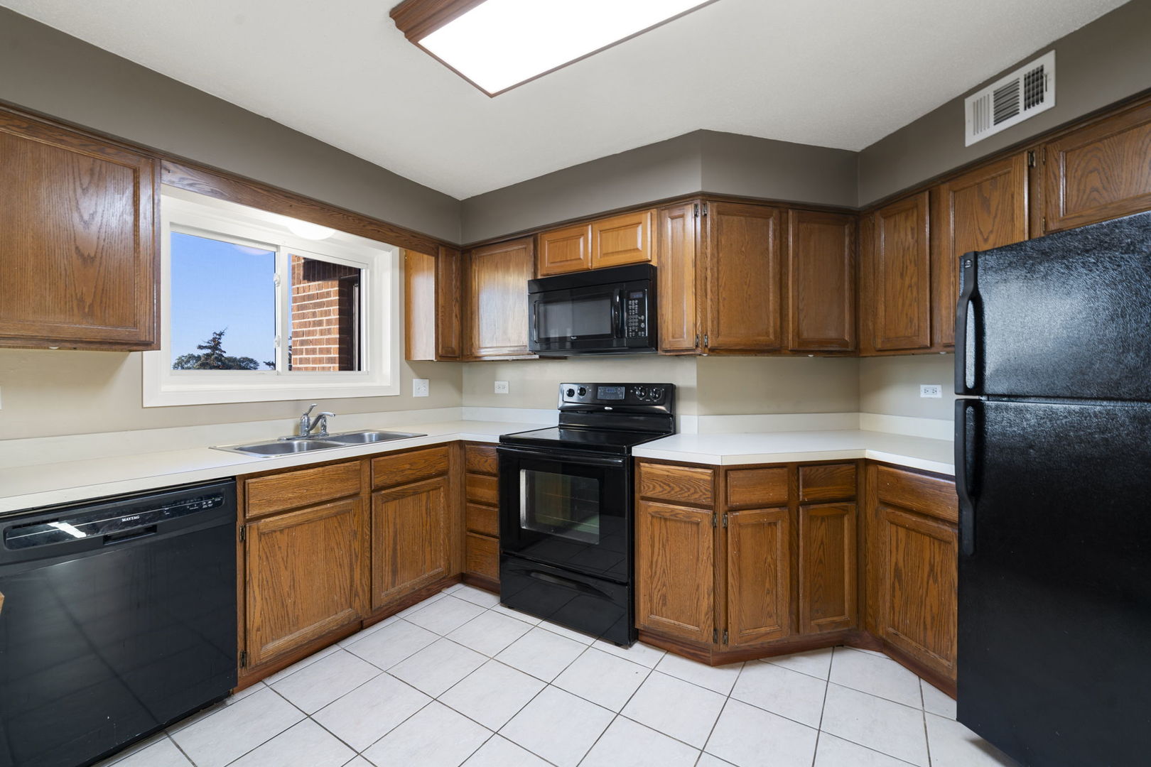 6421 Pershing Road, Unit 404 Berwyn, IL 60402 - Photo 8 of 31 a kitchen with stainless steel appliances granite countertop a sink stove and refrigerator