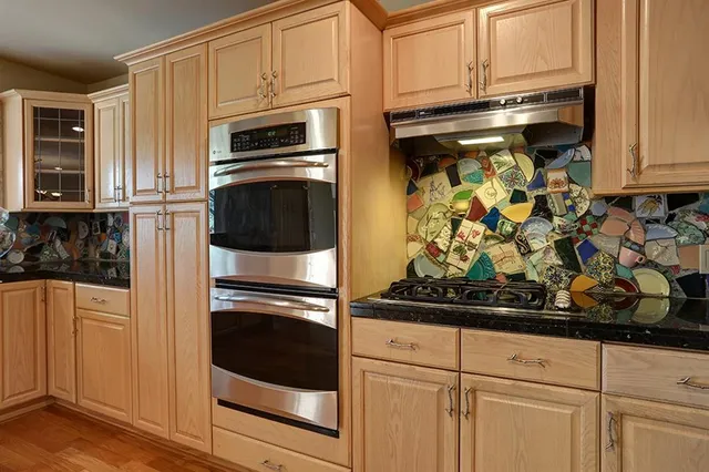 a view of a kitchen with refrigerator and table