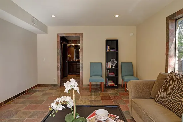 a bathroom with sink shower and mirror