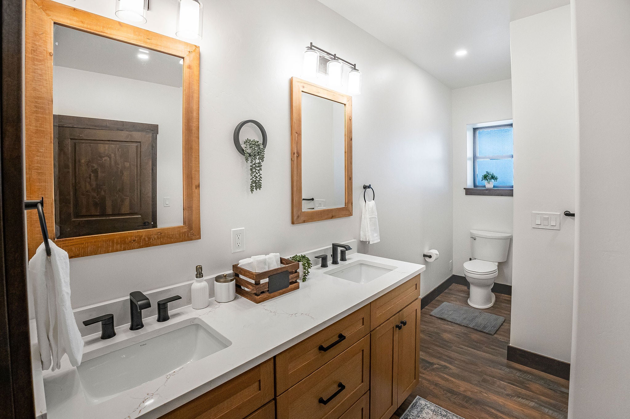 77 Rumsey Road Philipsburg, MT 59858 - Photo 33 of 76 Bathroom featuring toilet, wood finished floors, double vanity, baseboards, and recessed lighting