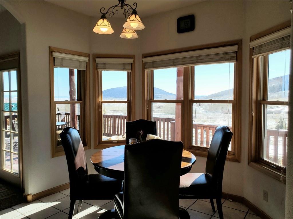114 Round Hill Road Fairplay, CO 80440 - Photo 12 of 35 a dining room with furniture a chandelier and wooden floor