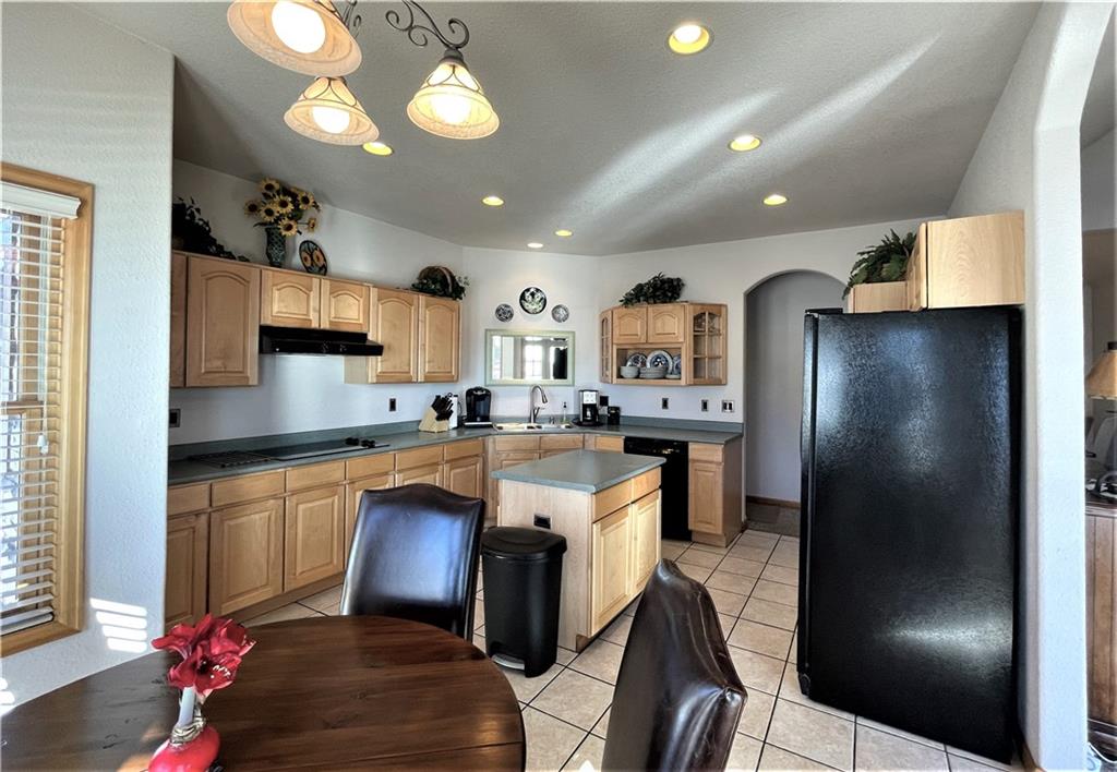 114 Round Hill Road Fairplay, CO 80440 - Photo 13 of 35 a kitchen with stainless steel appliances granite countertop a refrigerator a stove a sink dishwasher and a refrigerator with wooden floor