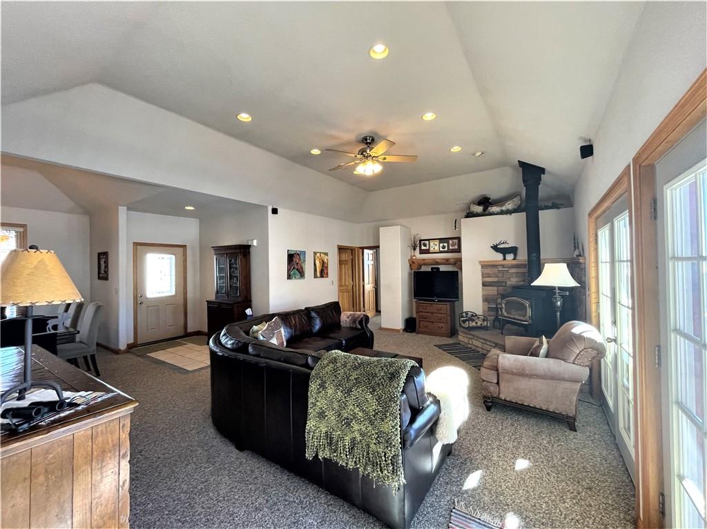 114 Round Hill Road Fairplay, CO 80440 - Photo 9 of 35 a living room with furniture a large window and a fireplace