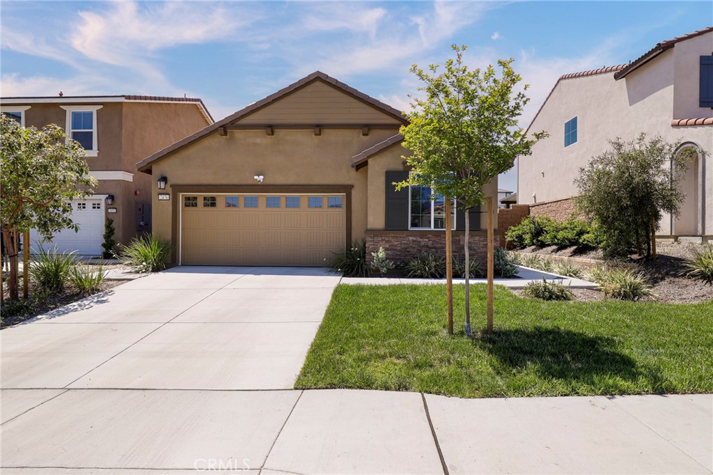 a front view of a house with a yard and garage