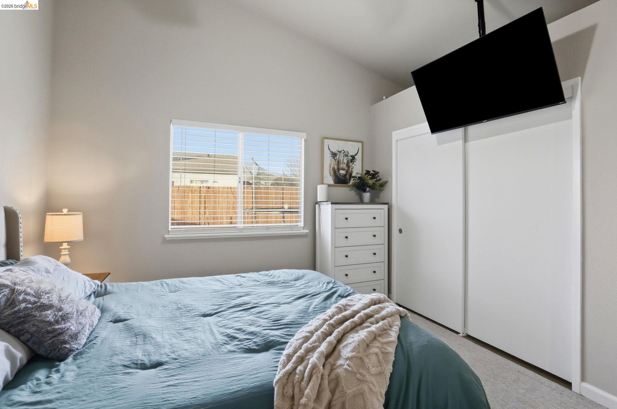 799 Morgans Ranch Circle Galt, CA 95632 - Photo 18 of 36 Carpeted bedroom featuring a closet and vaulted ceiling