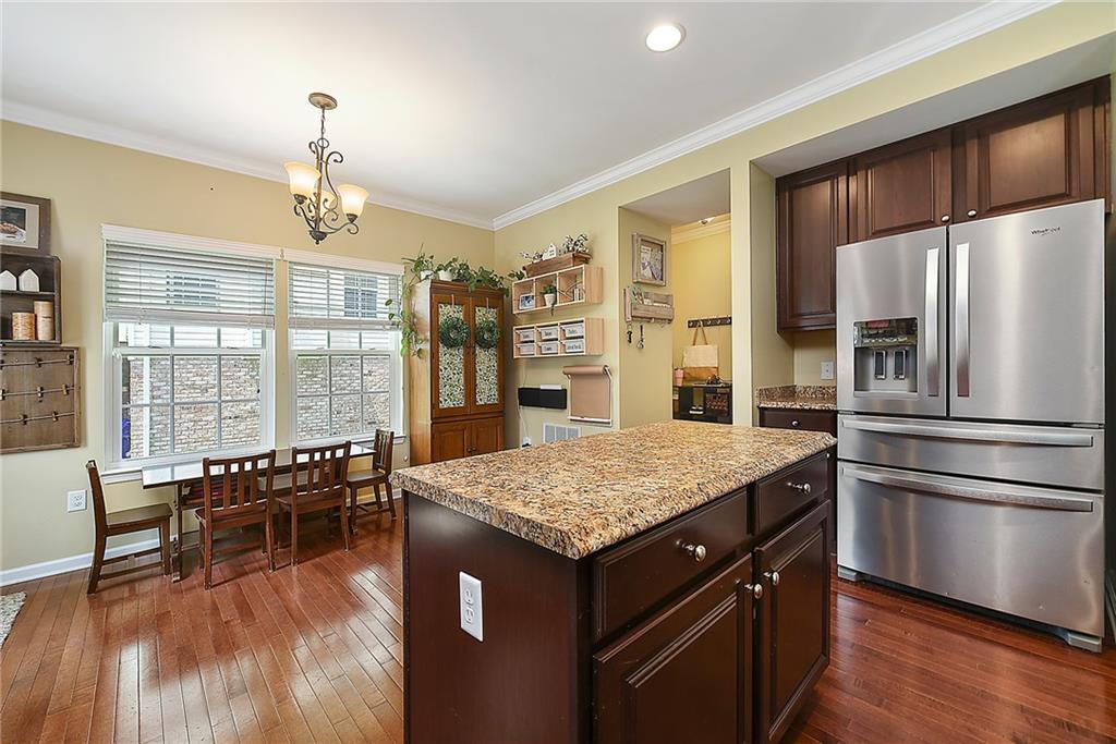 179 Broadstone Drive Mars, PA 16046 - Photo 12 of 25 a kitchen with a center island wooden floor and stainless steel appliances
