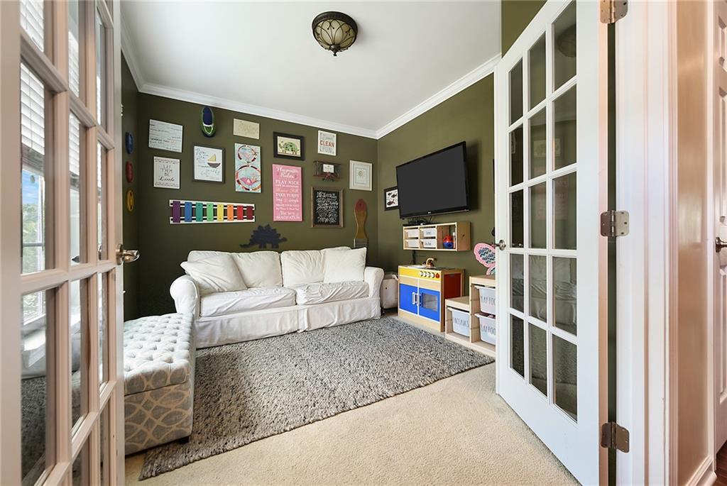179 Broadstone Drive Mars, PA 16046 - Photo 3 of 25 a living room with furniture a flat screen tv and a floor to ceiling window