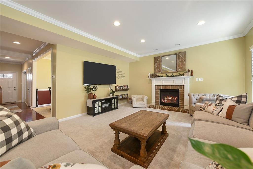 179 Broadstone Drive Mars, PA 16046 - Photo 5 of 25 a living room with furniture a flat screen tv and a fireplace
