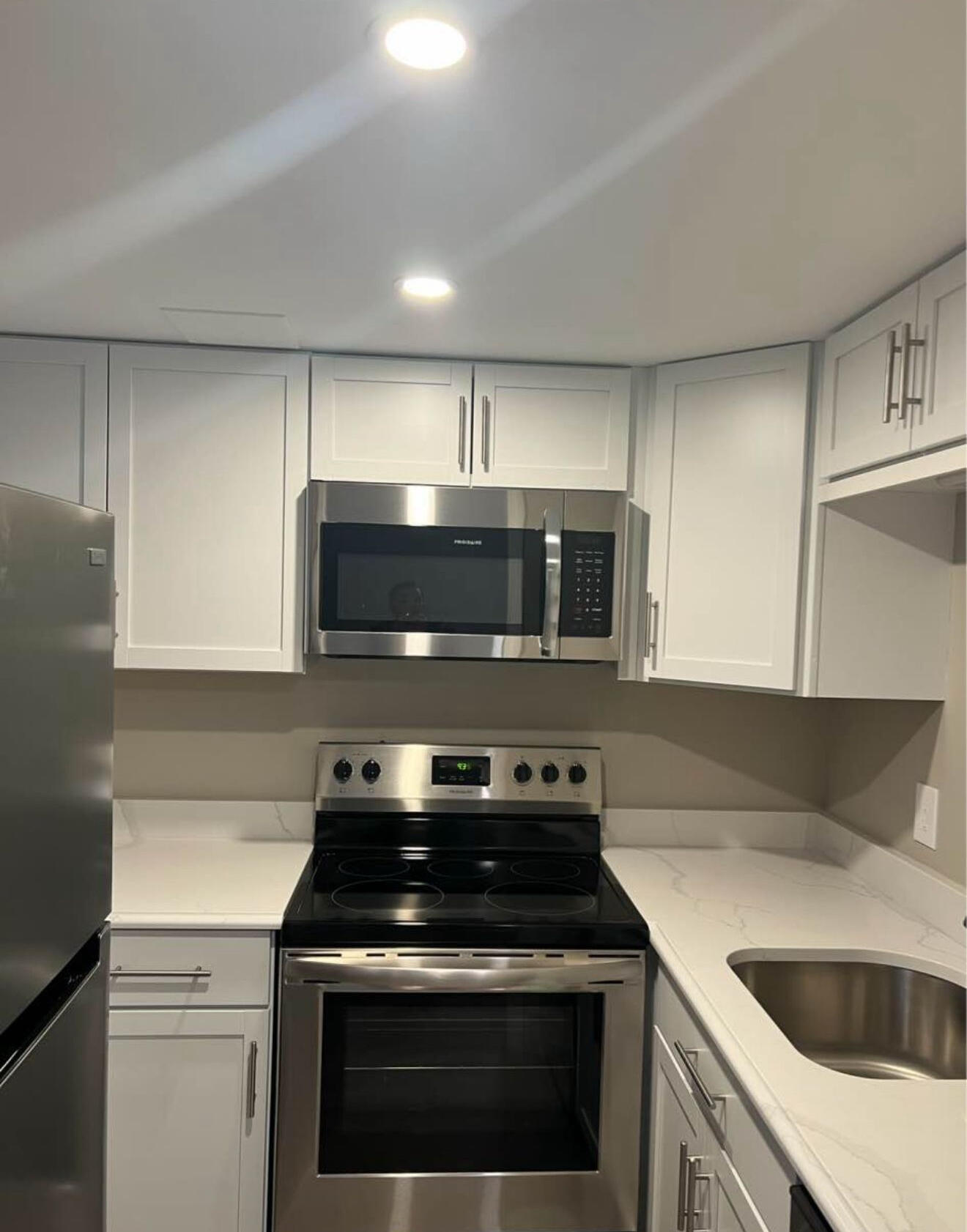 135 West Main Street, Unit 26 Hyannis, MA 02601 - Photo 4 of 9 a kitchen with stainless steel appliances granite countertop a sink and a stove