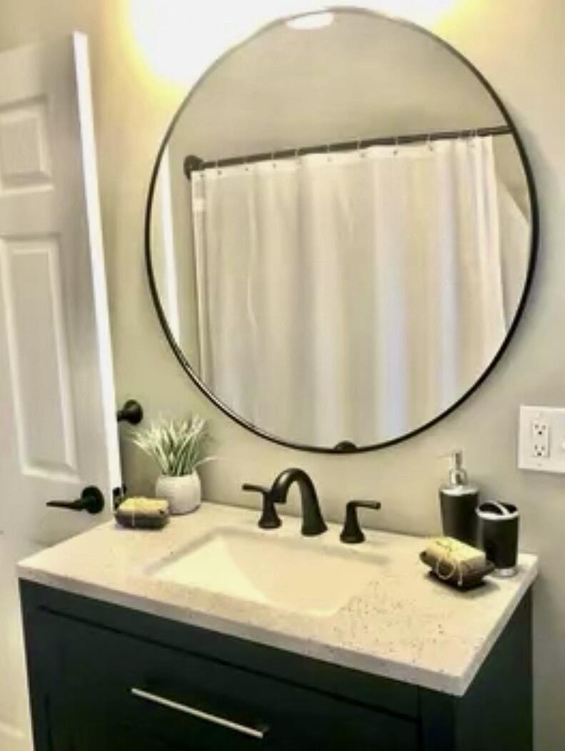 135 West Main Street, Unit 26 Hyannis, MA 02601 - Photo 8 of 9 a bathroom with a sink and a mirror