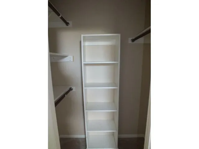 a picture of a room with a door and a cabinet