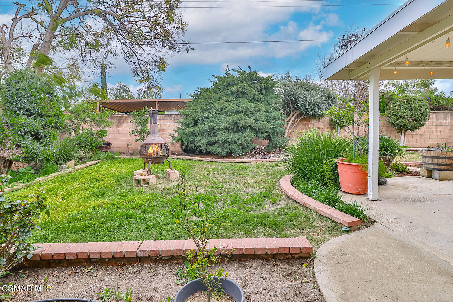 1648 Spence Street Simi Valley, CA 93065 - Photo 37 of 41 a view of a garden with a bench in front of the house