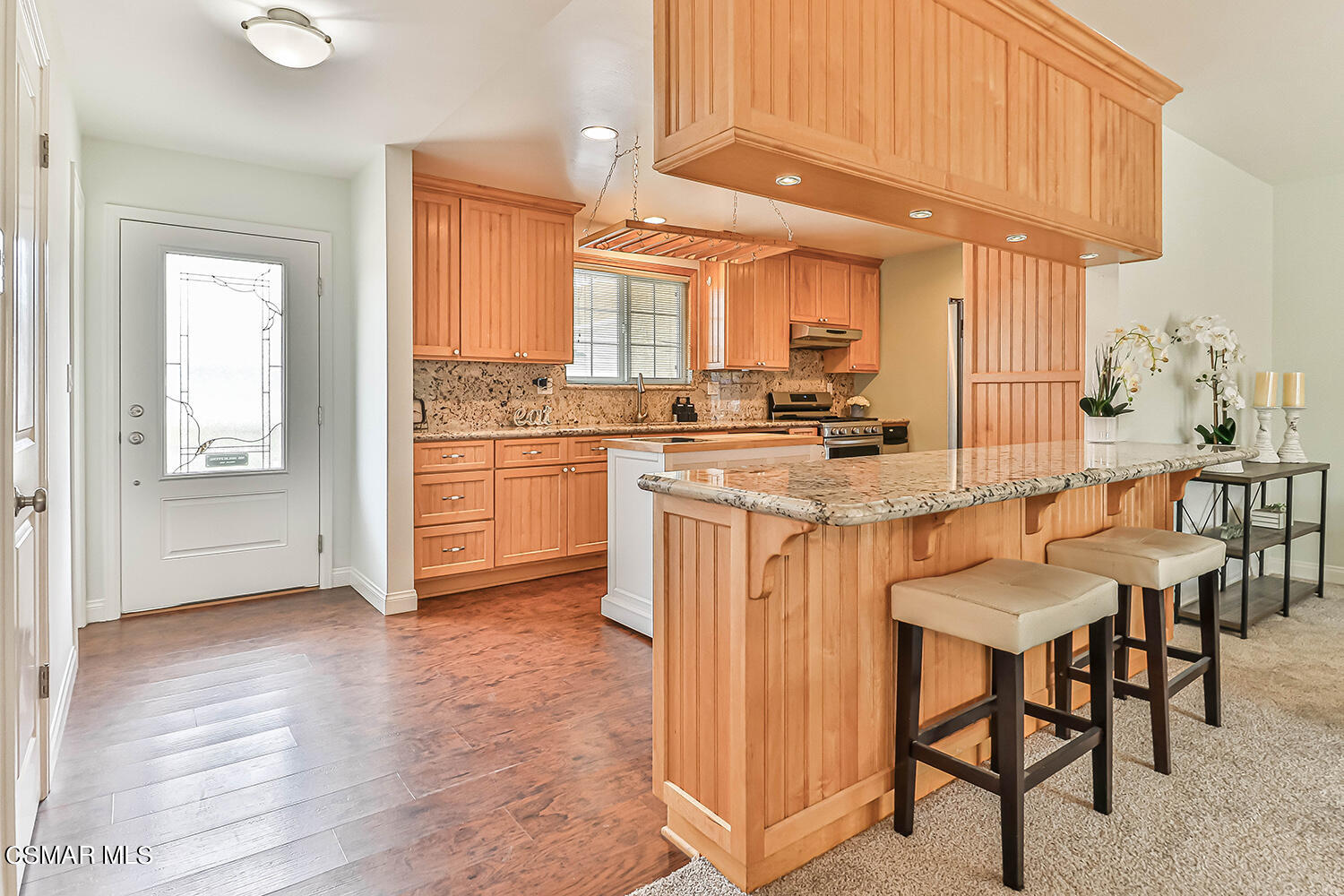1648 Spence Street Simi Valley, CA 93065 - Photo 4 of 41 a kitchen with stainless steel appliances granite countertop a stove a sink dishwasher and a refrigerator with wooden cabinets