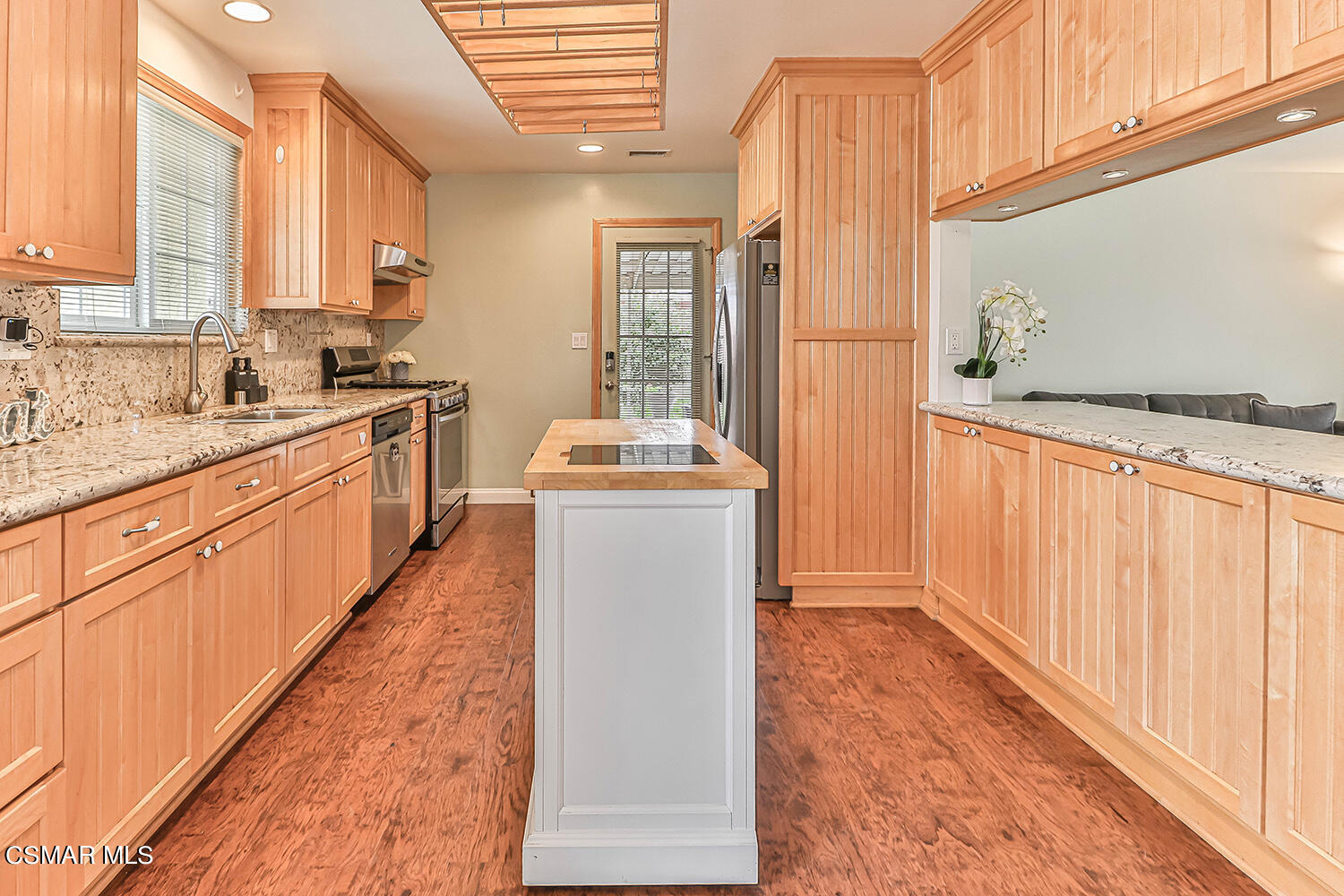 1648 Spence Street Simi Valley, CA 93065 - Photo 5 of 41 a kitchen with granite countertop a sink a counter top space and cabinets