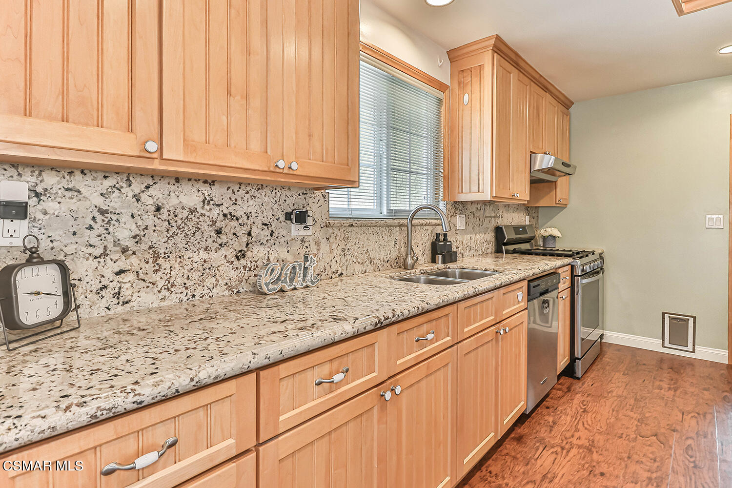 1648 Spence Street Simi Valley, CA 93065 - Photo 6 of 41 a kitchen with granite countertop white cabinets and white appliances