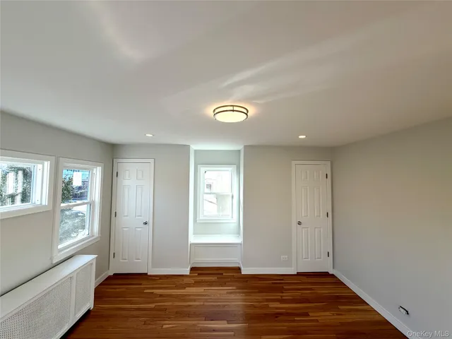 a view of room with window and wooden floor