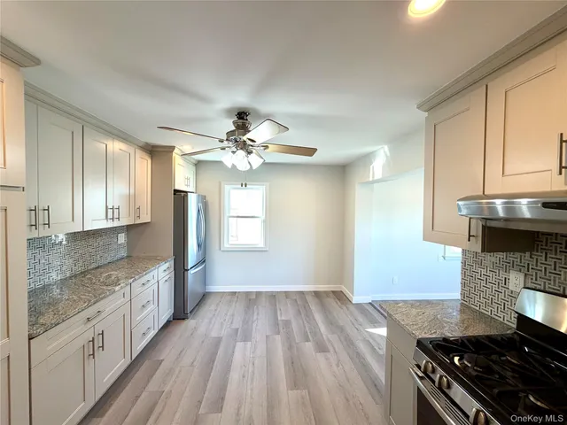a kitchen with granite countertop a stove and a sink