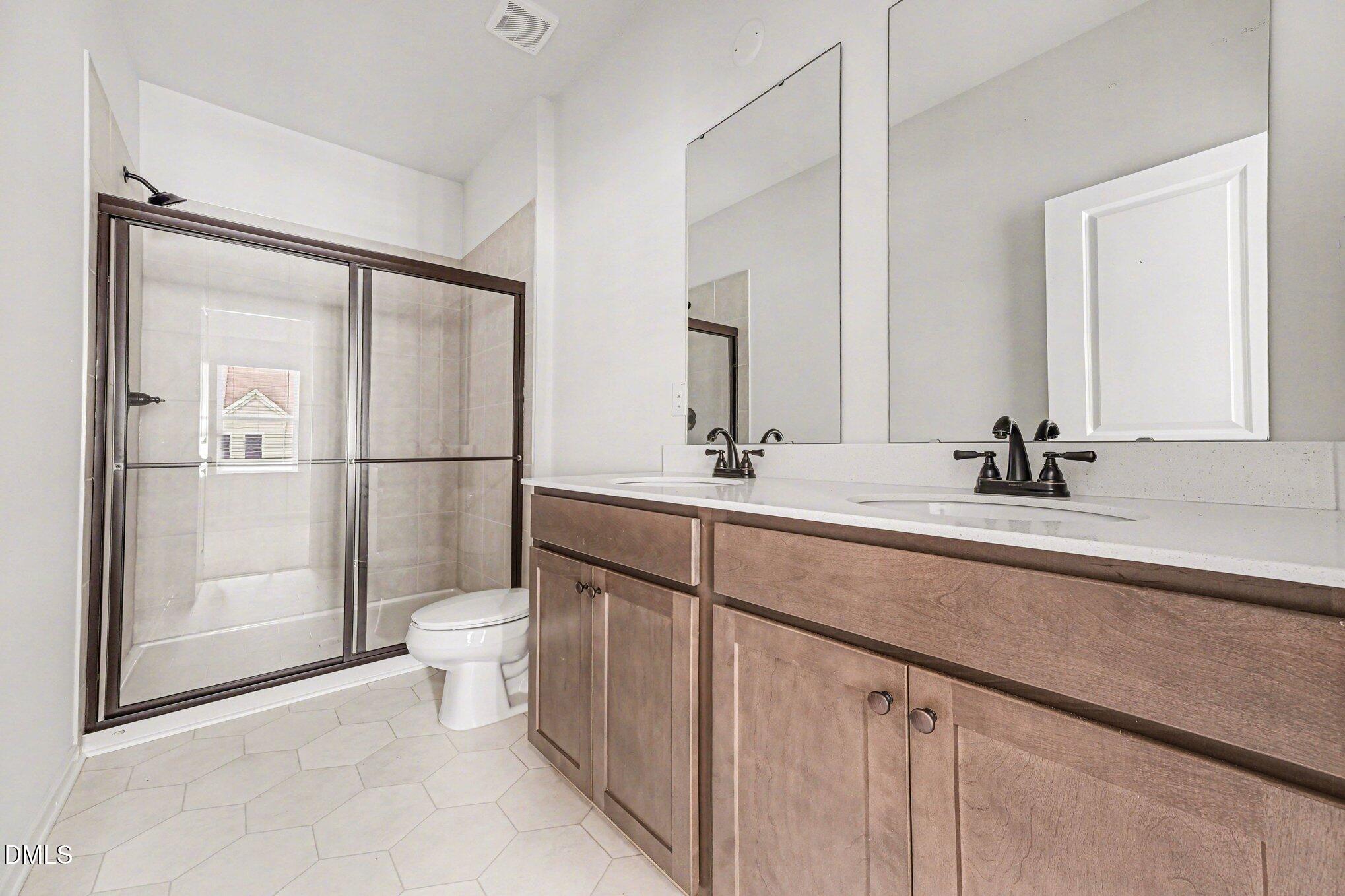 722 Orch Vista Circle Raleigh, NC 27606 - Photo 11 of 28 a bathroom with a toilet a sink and mirror
