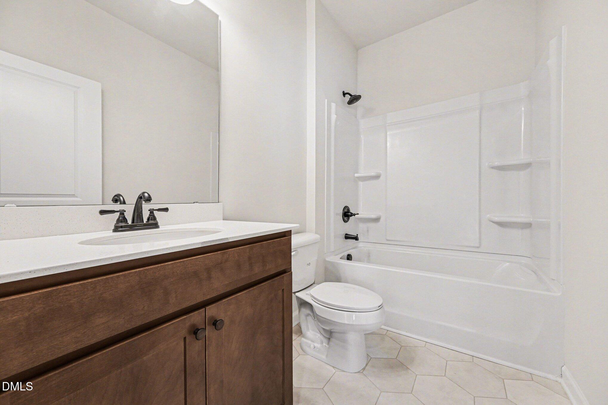 722 Orch Vista Circle Raleigh, NC 27606 - Photo 14 of 28 a bathroom with a sink a toilet and shower