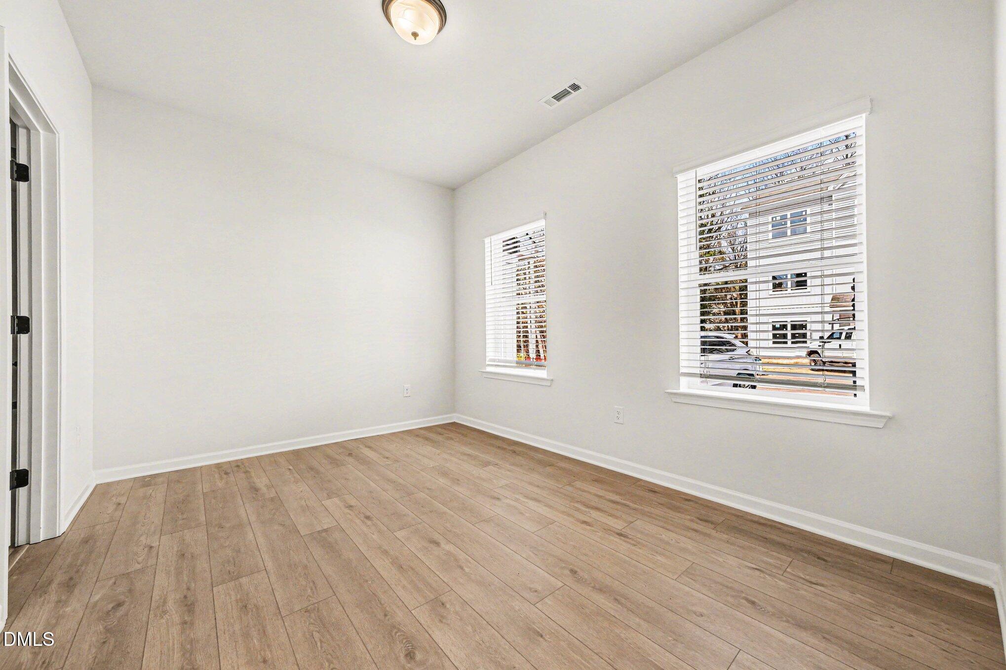 722 Orch Vista Circle Raleigh, NC 27606 - Photo 16 of 28 an empty room with wooden floor and windows